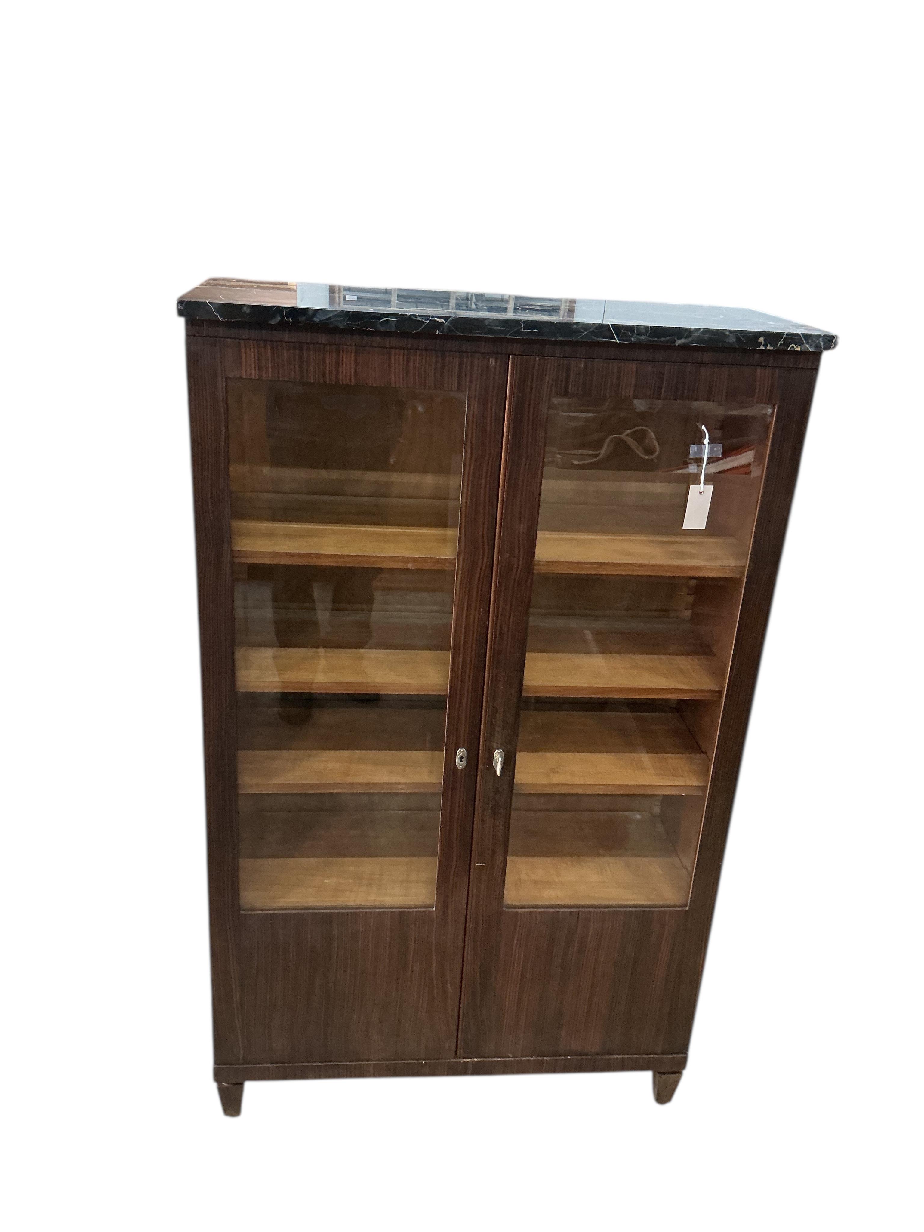 A French Art Deco marble topped coromandel bookcase, width 92cm, depth 38cm, height 151cm